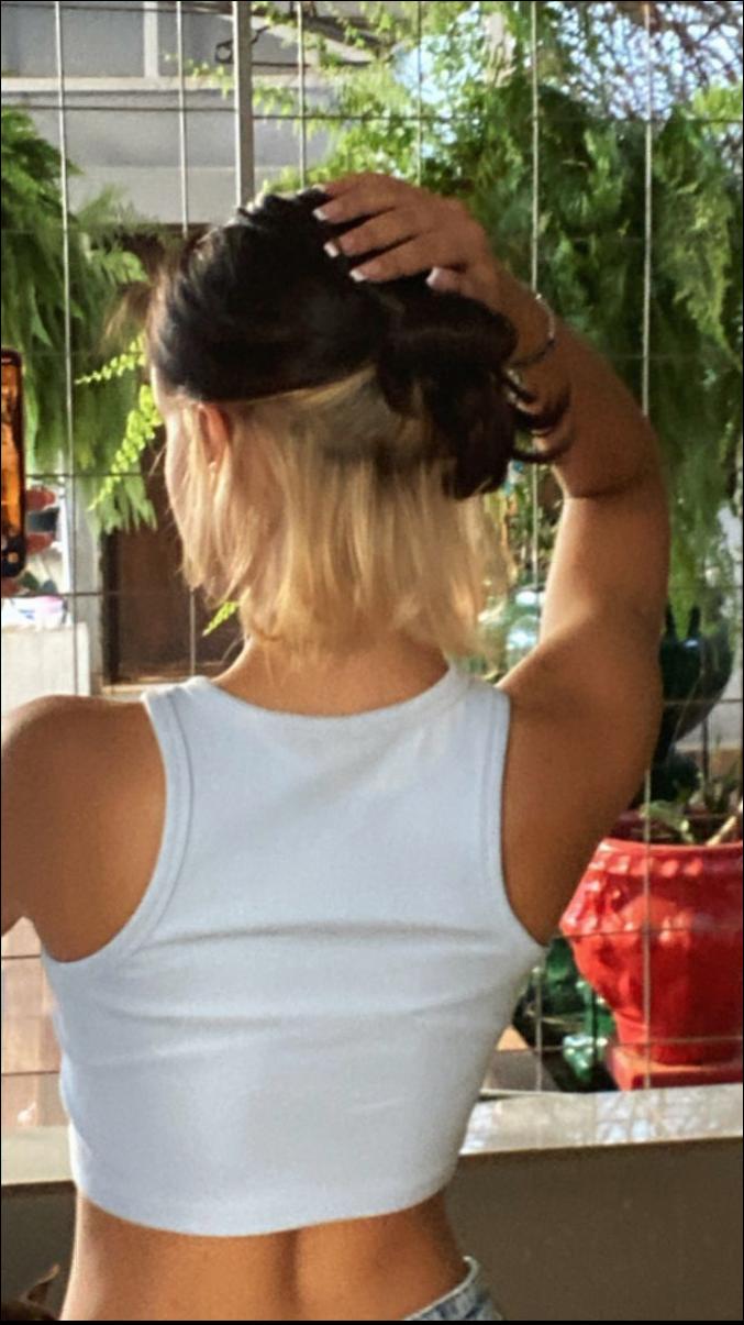 a woman is standing on a ledge with a blue towel