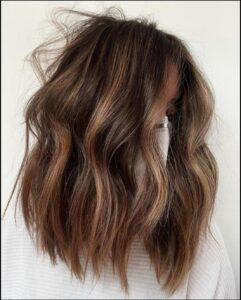 a woman with a black hair and a white shirt