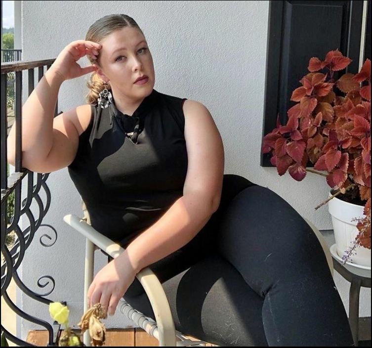 a woman sitting on a bench with a flower in her hand