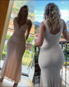 a woman standing next to a man in a white dress