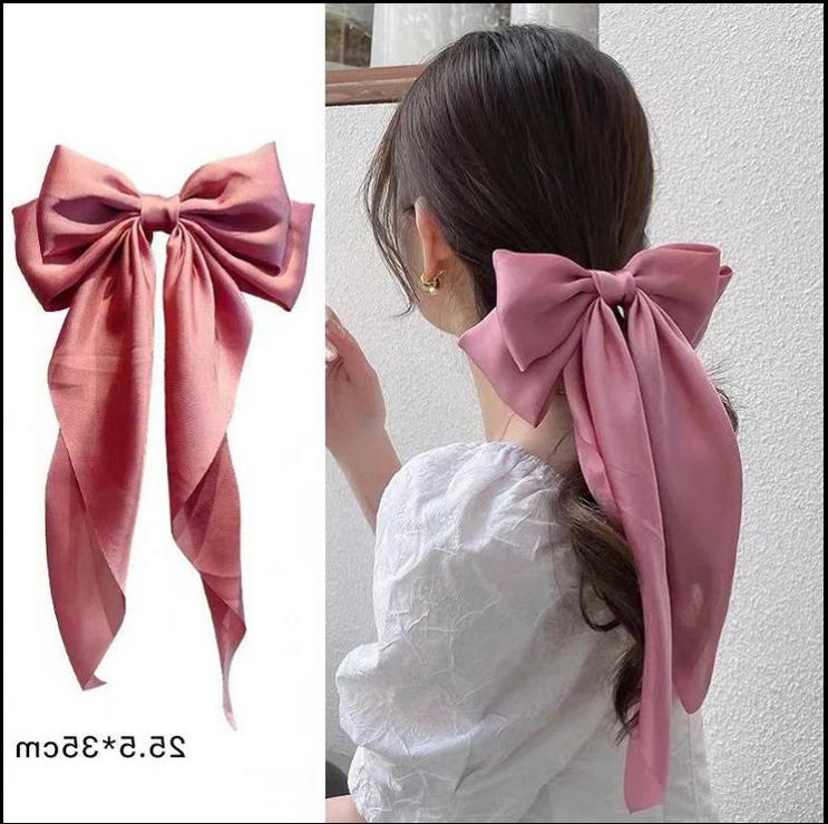 a woman wearing a red dress and a red bow tie