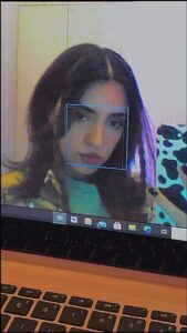 a woman is looking at a laptop on a desk