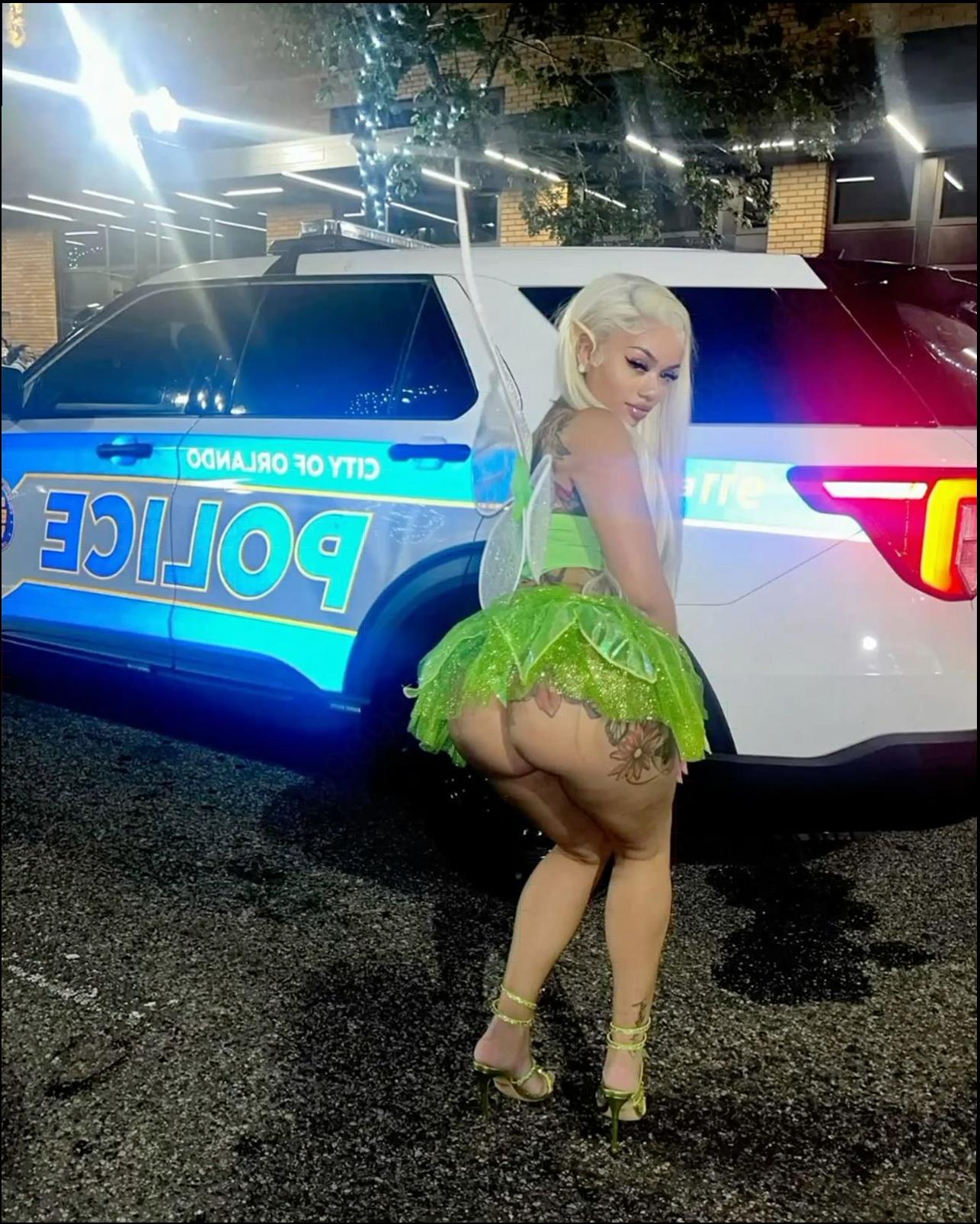 a woman in a pink dress is holding a pink umbrella