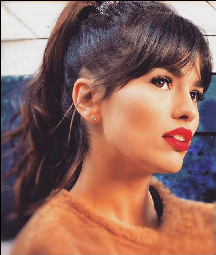 a woman with a red hair and a blue neck tie