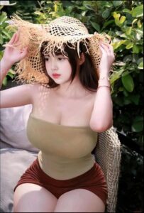 a woman in a white dress holding a white hat