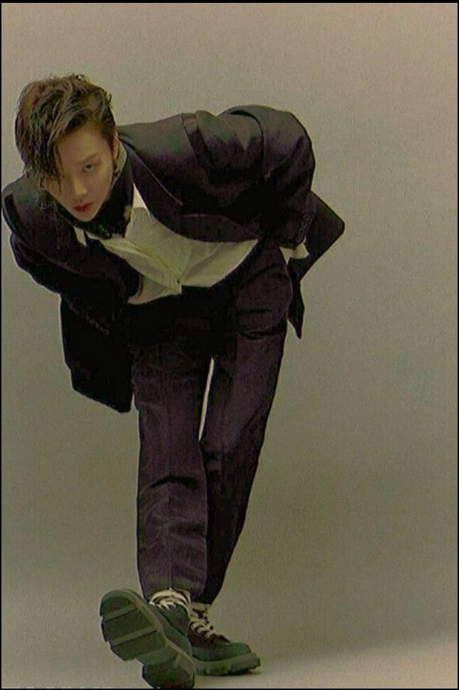 a woman is laying on a bed with a shoe