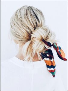 a woman wearing a tie with a flower on it