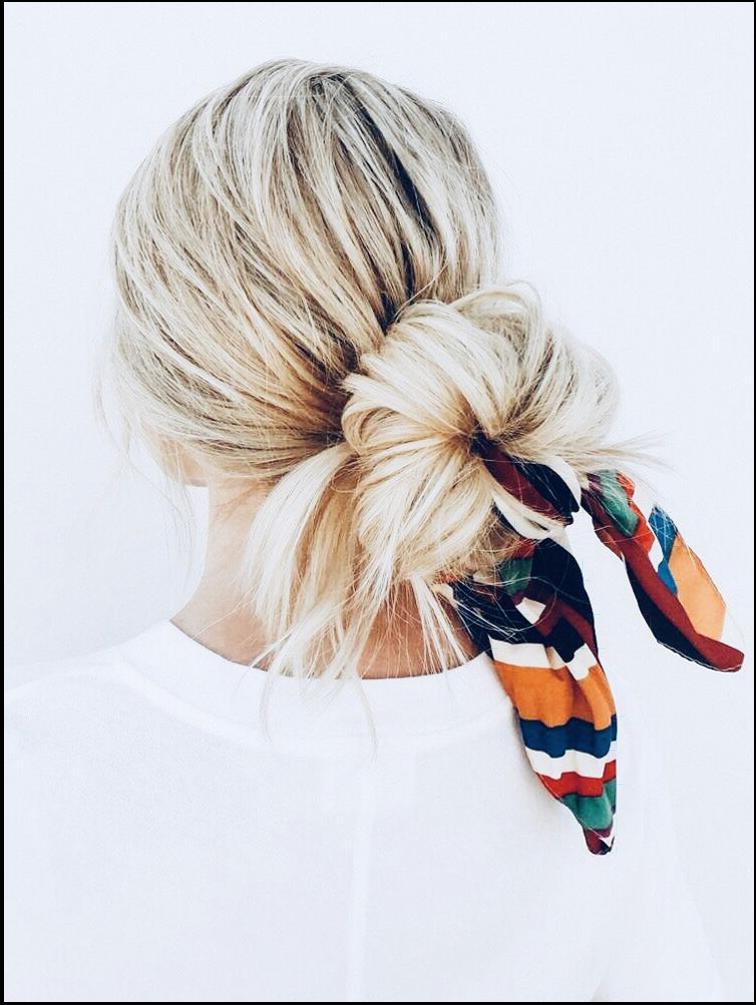 a woman wearing a tie with a flower on it