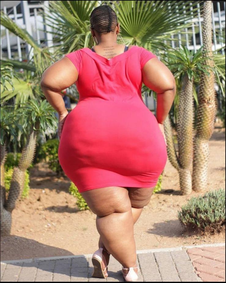 a woman in a red dress is on a red and white checkered bench
