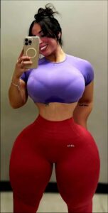 a woman in a red dress is holding a pink and white object