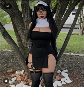 a woman in a black dress and a black hat