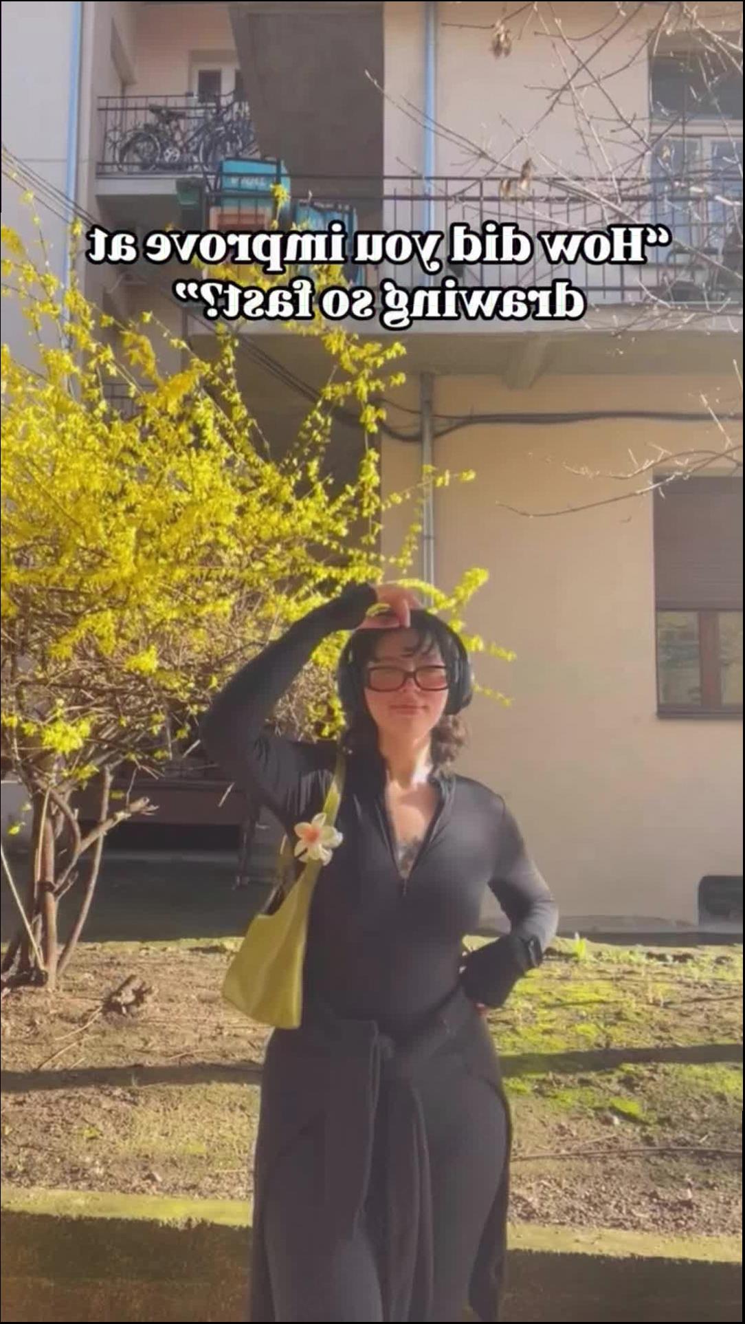 a woman in a black dress holding a white umbrella