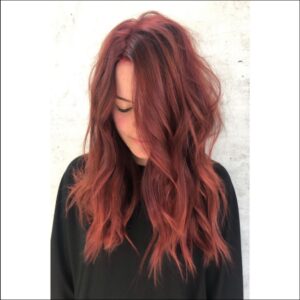 a woman is standing in front of a wall