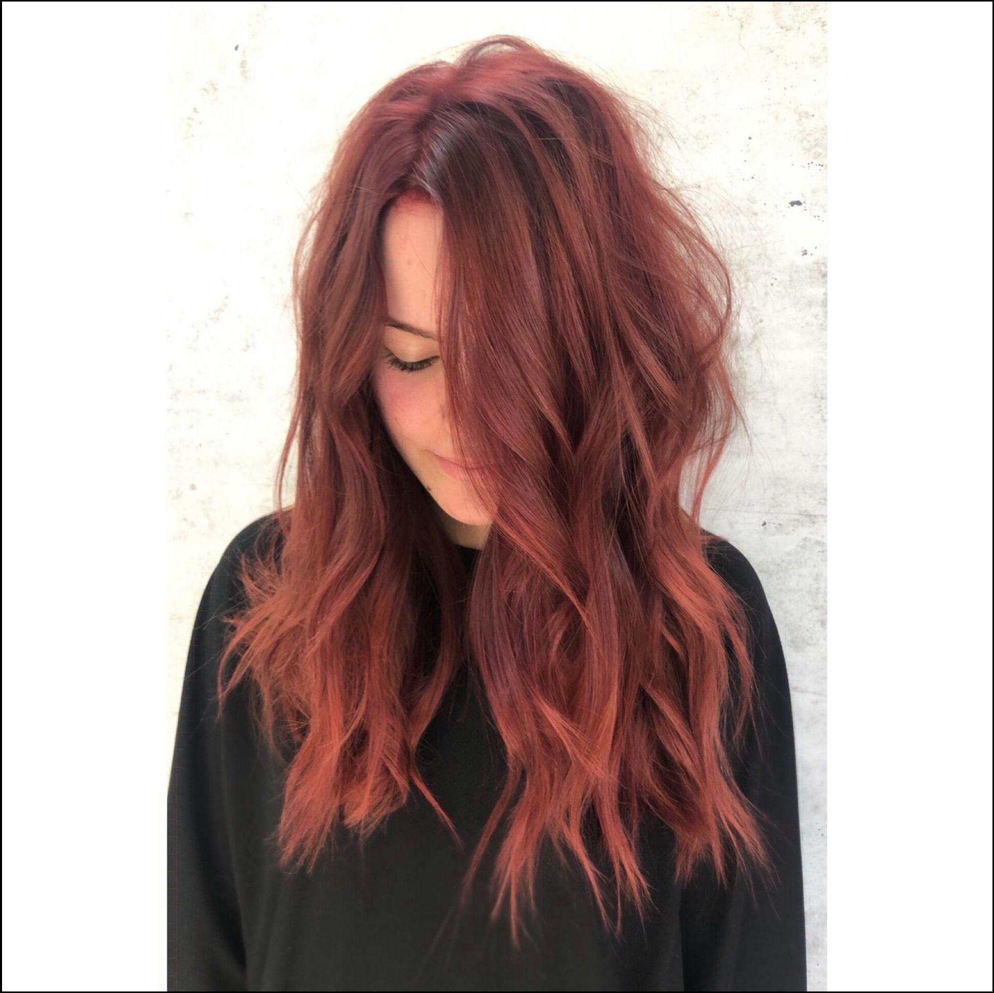 a woman is standing in front of a wall