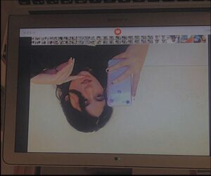 a woman is holding a tv on a tv screen