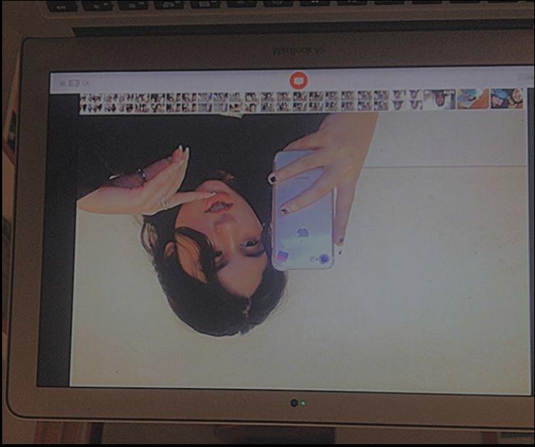 a woman is holding a tv on a tv screen