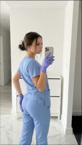 a woman in a blue dress holding a blue object