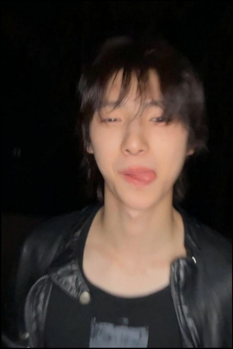 a woman with a black hair and a black tie