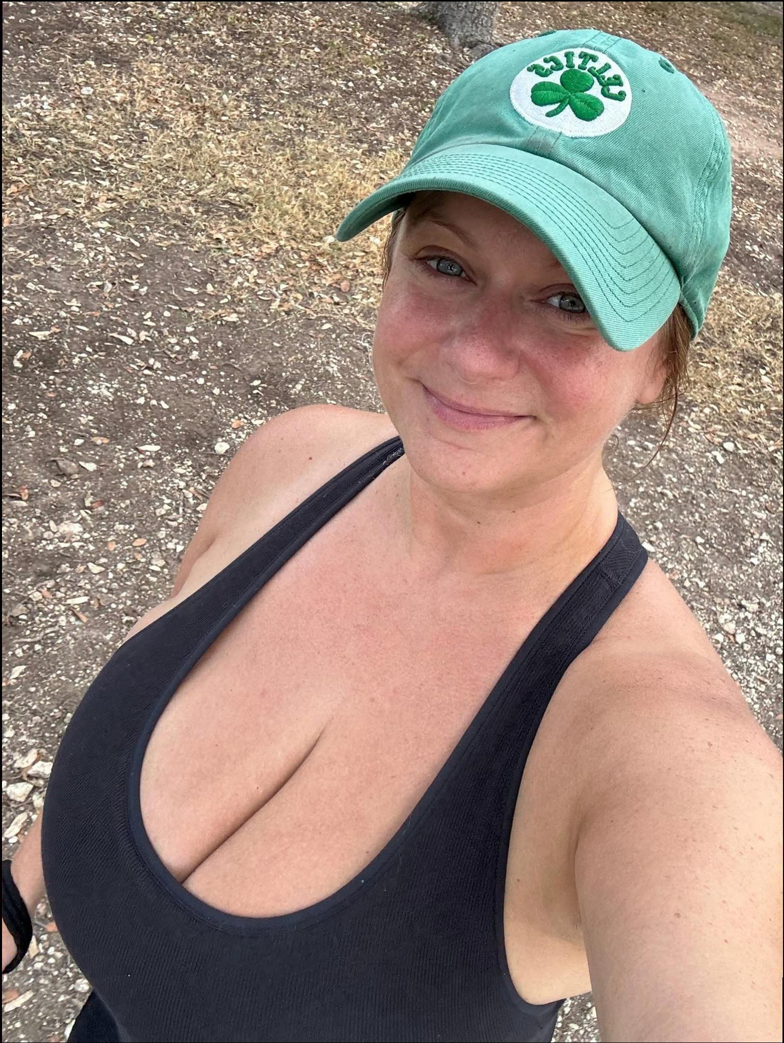 a woman wearing a hat and a green shirt