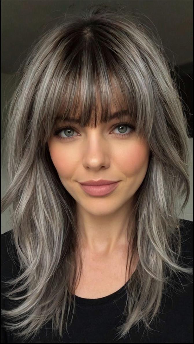 a woman with a black hair and a black tie