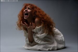 a woman is laying down on a white sheet