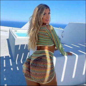 a woman in a white dress standing on a ledge