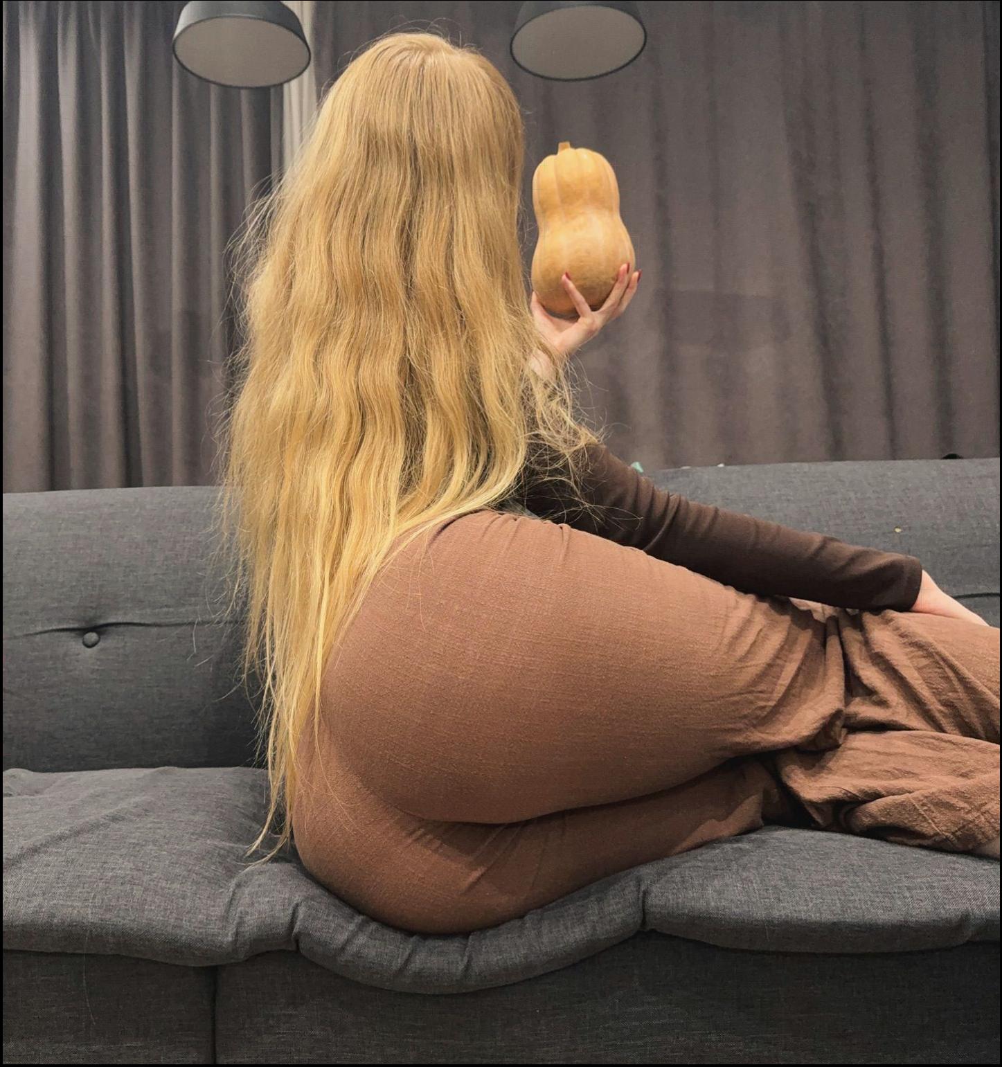 a woman is sitting on a couch with a stuffed animal