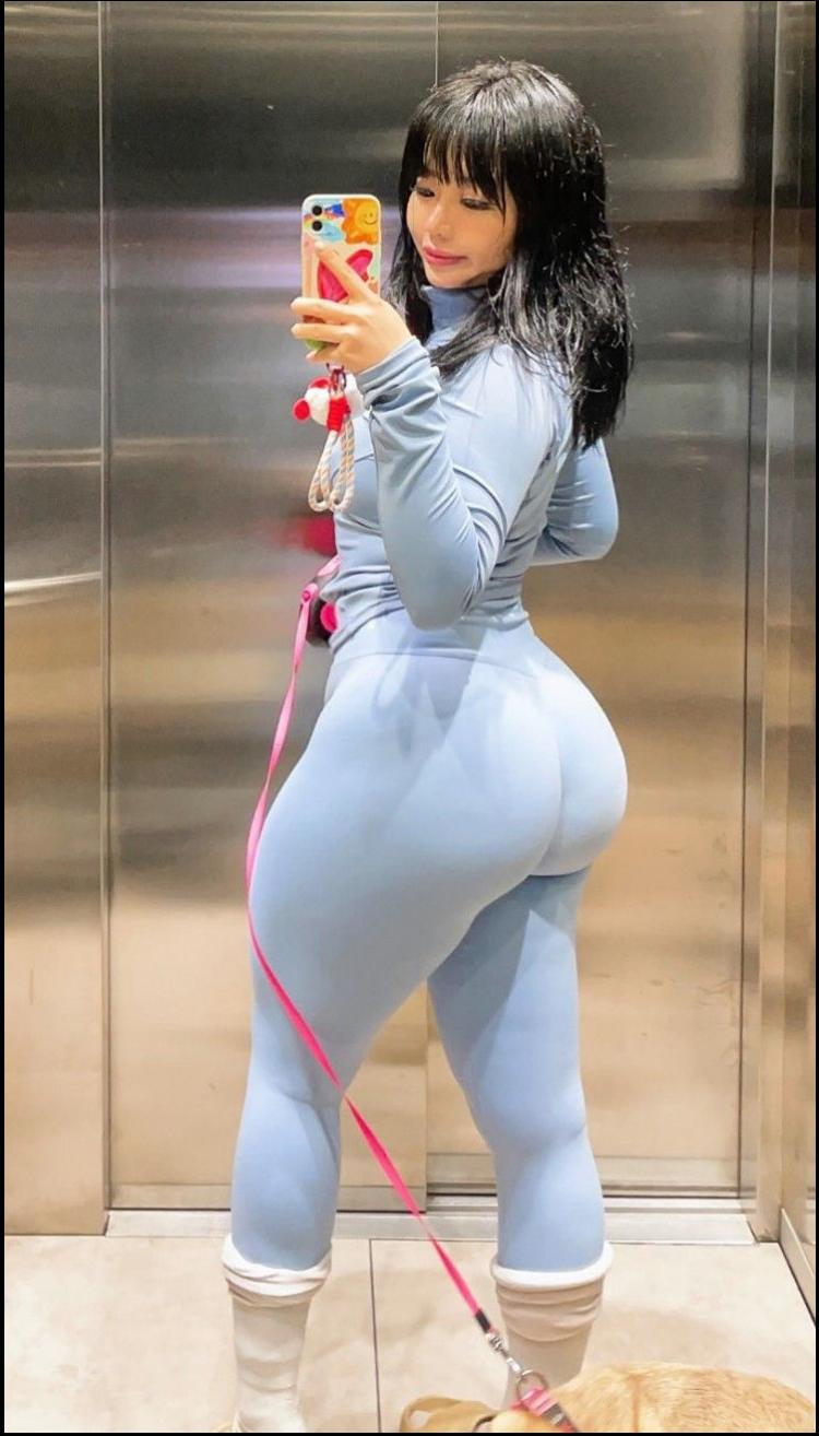 a woman is holding a hot dog in a bun