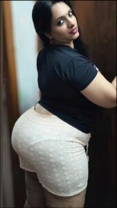 a woman in a black shirt and black pants is posing for a picture