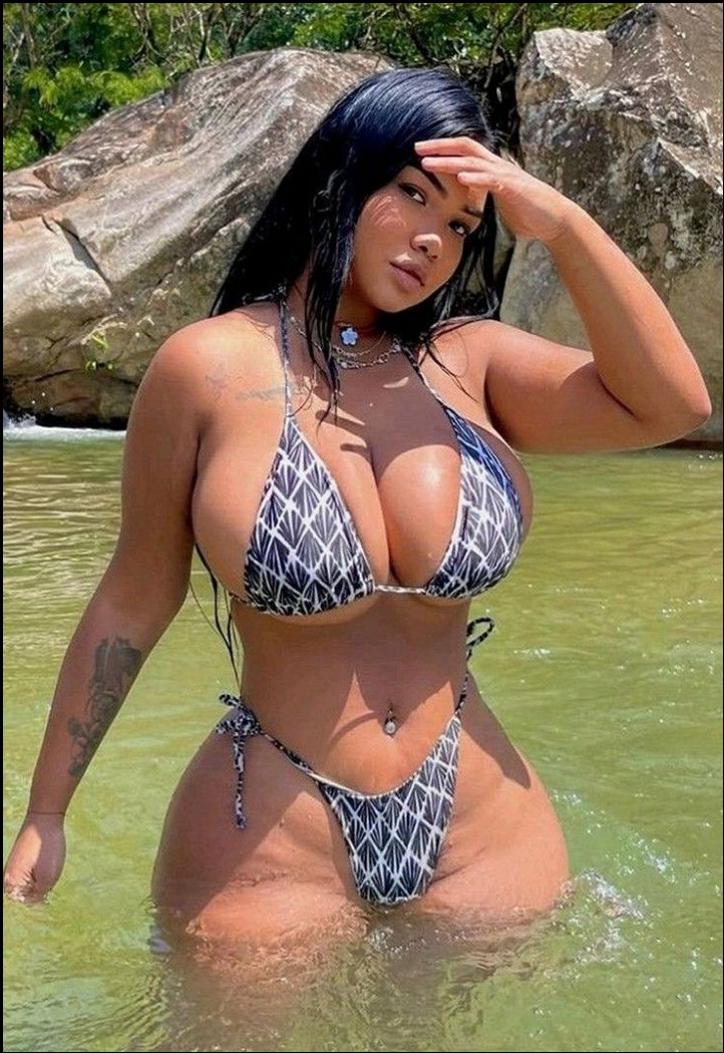 a woman in a bikini posing for a picture