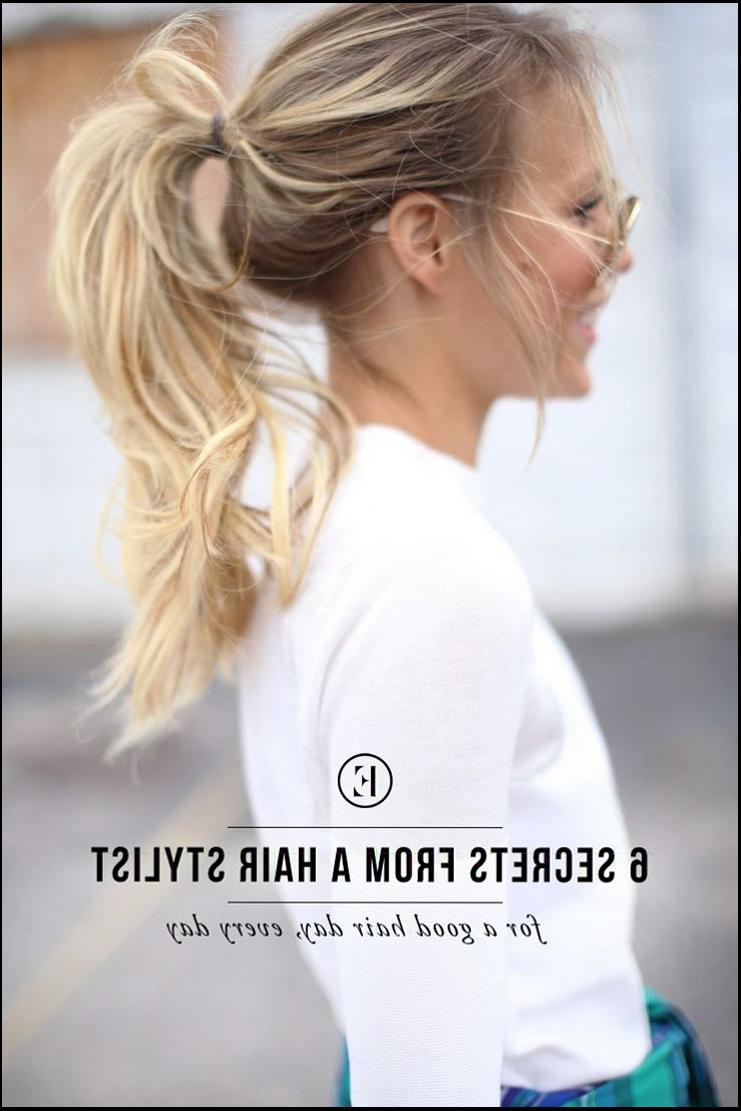 a woman is standing in front of a wall