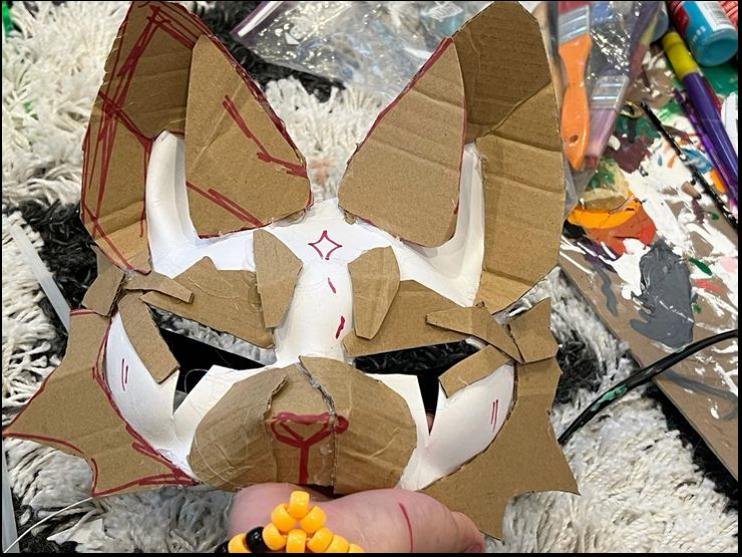 a person is holding a box with a cat on it