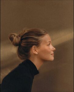 a woman with a black hair and a black top