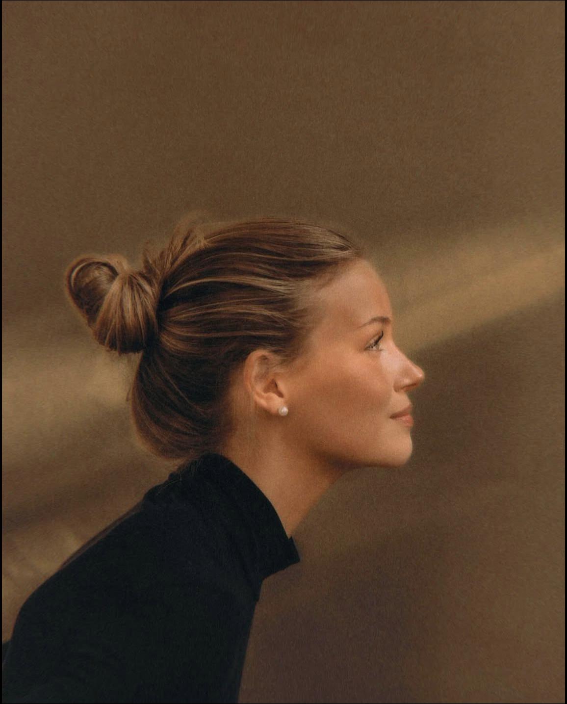 a woman with a black hair and a black top