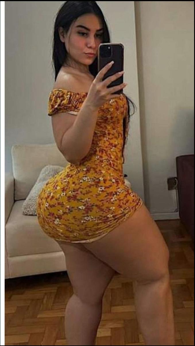 a woman is posing for a picture with a cell phone