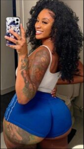 a woman is holding a cell phone in her hand