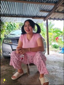 a woman sitting on a bench with a pink umbrella