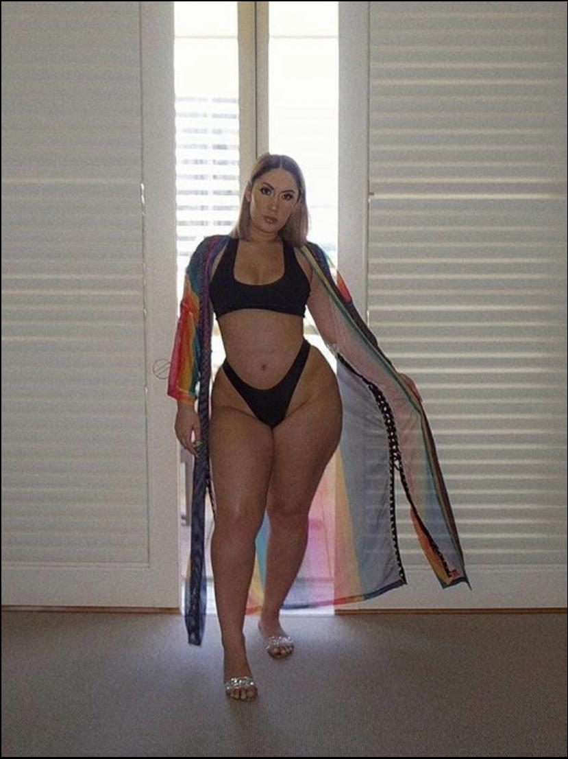 a woman in a bikini holding a surfboard