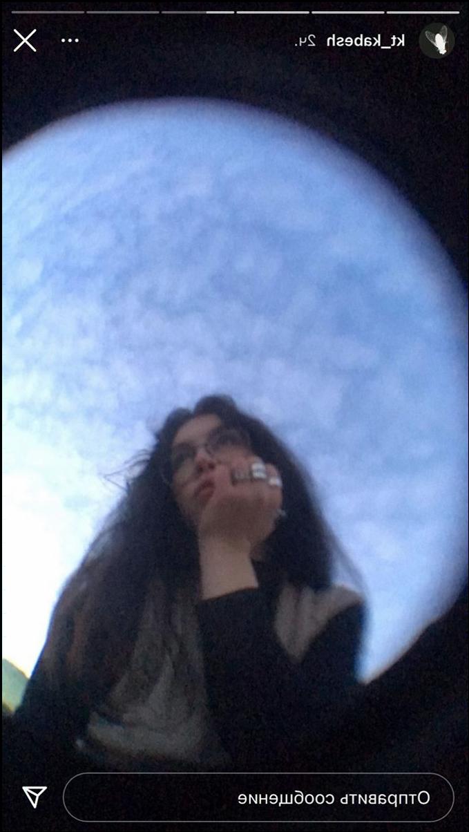 a woman is looking out the window of a building