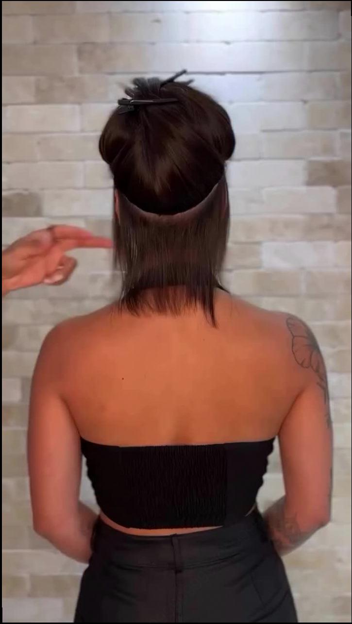 a woman wearing a black dress and a black tie