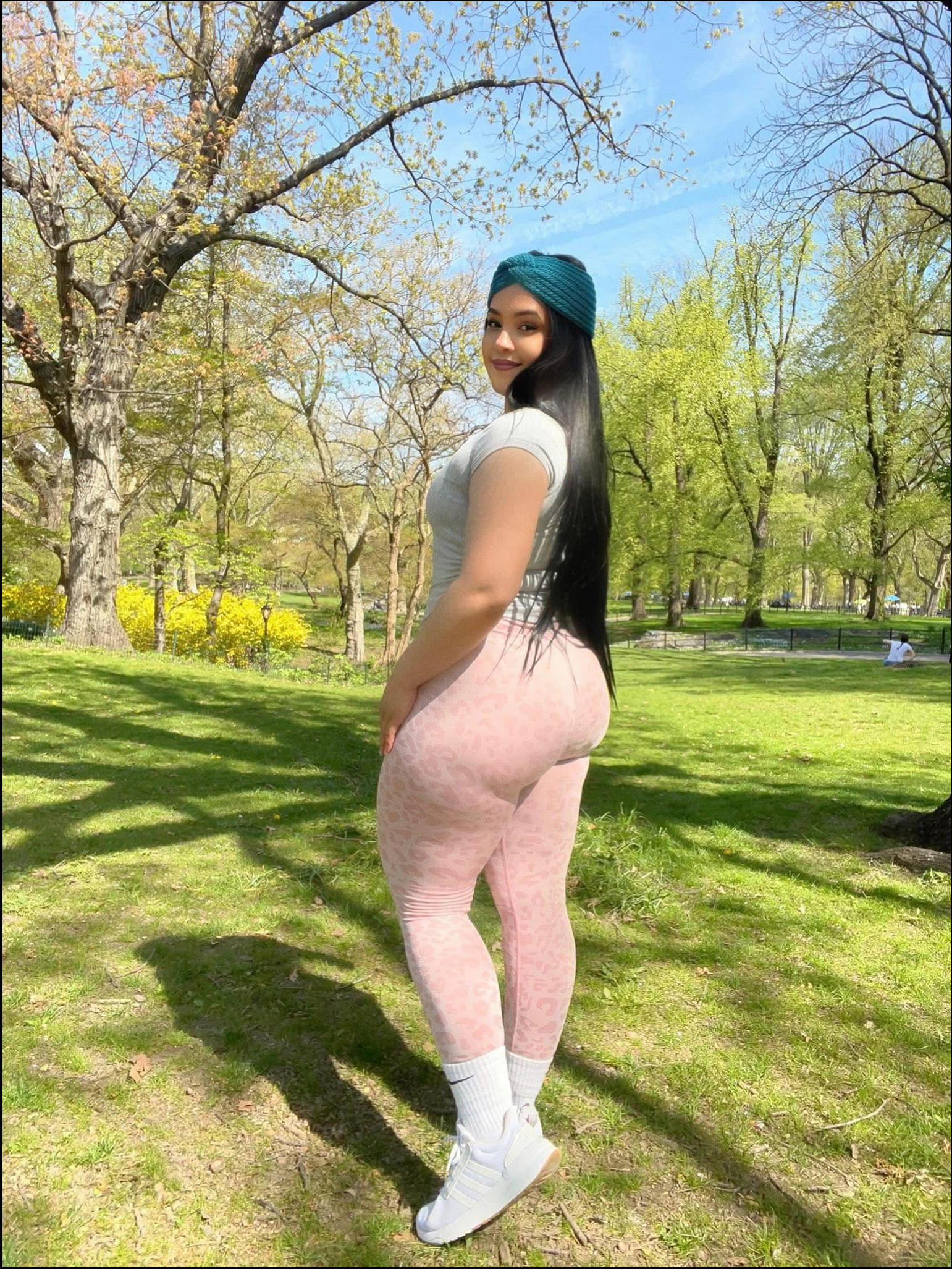 a woman in a pink dress posing for a picture