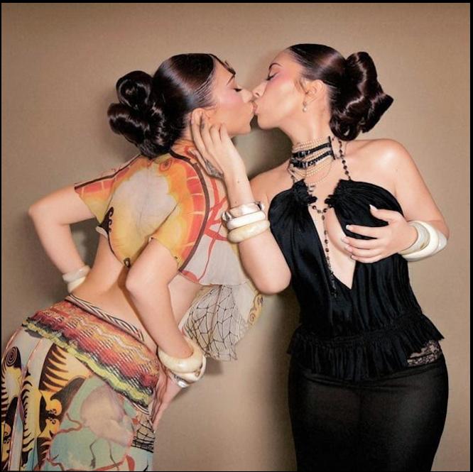 two women are dressed up and one is wearing a tie