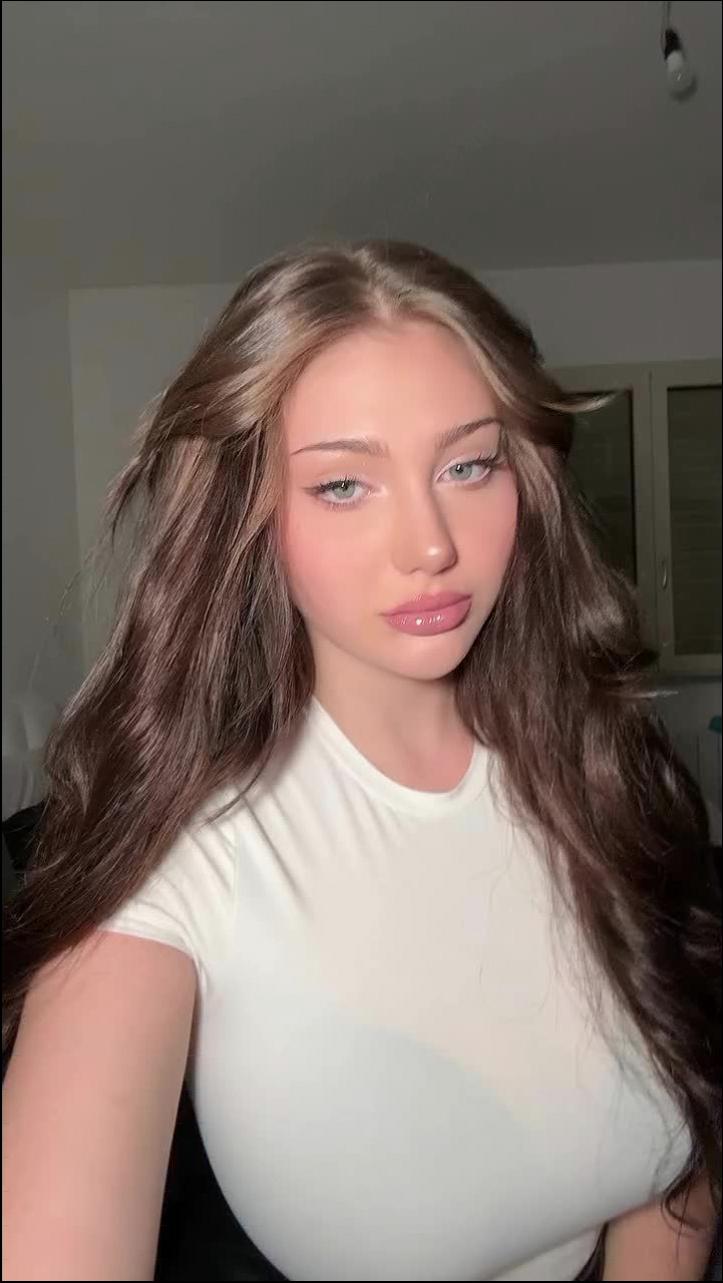 a woman is smiling and posing for a picture