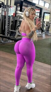 a woman in a pink dress is holding a pink object