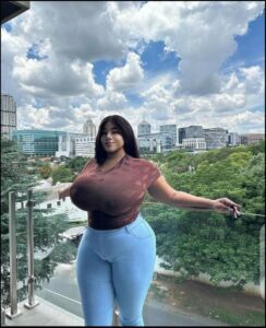 a woman standing in front of a large city