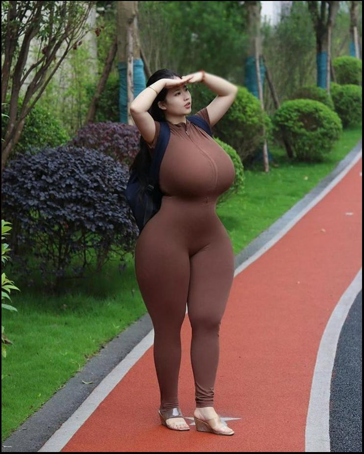 a woman in a black dress is standing on a sidewalk