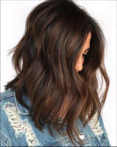 a woman is looking at the camera while wearing a black shirt