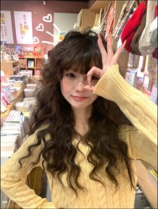 a woman in a red dress is standing in a store