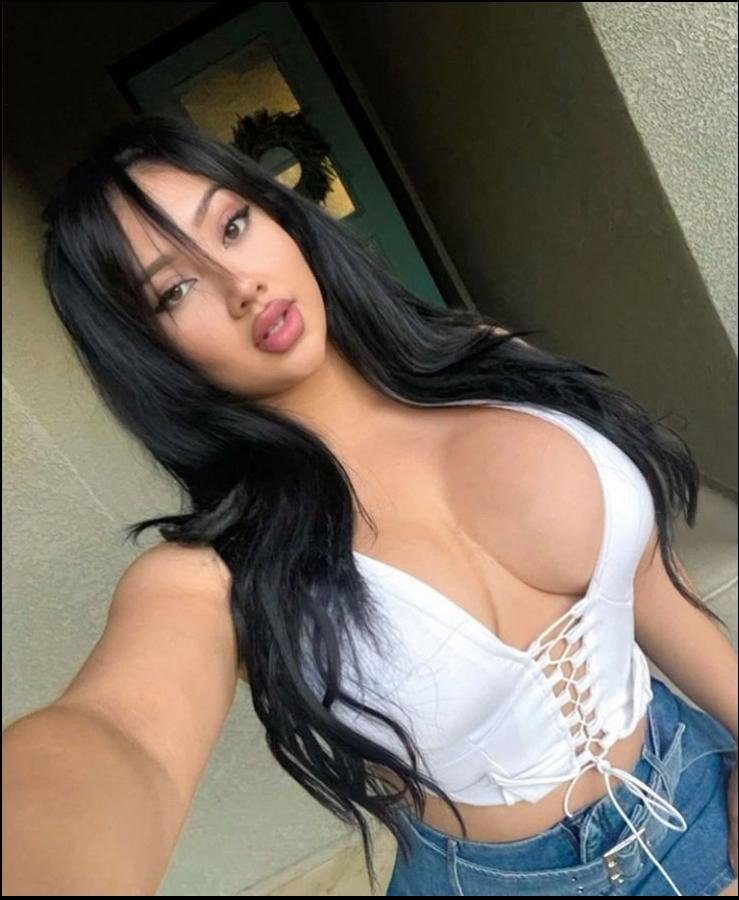 a woman is posing for a picture with a blue and white checkered shirt