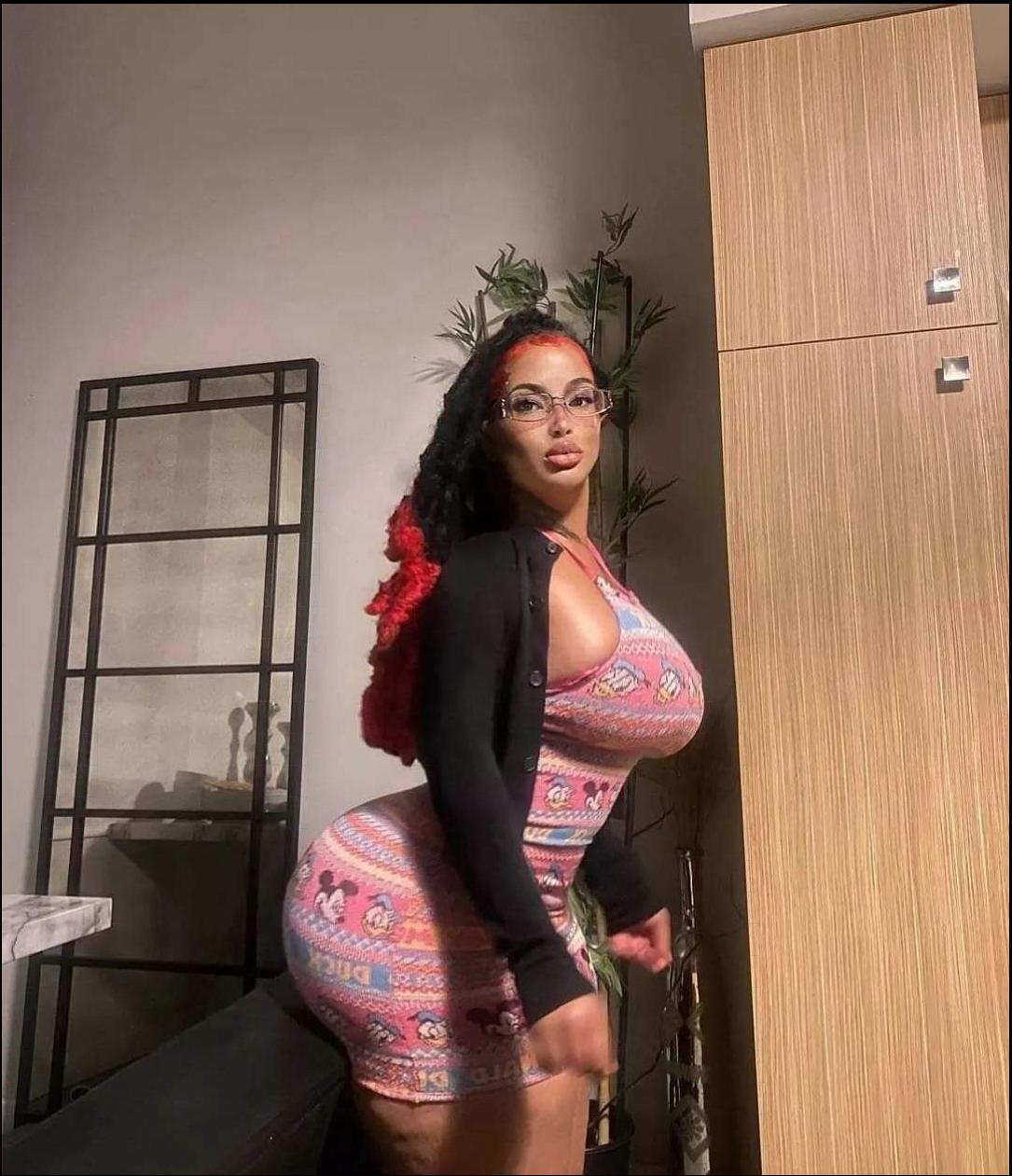 a woman in a pink dress is posing for a picture